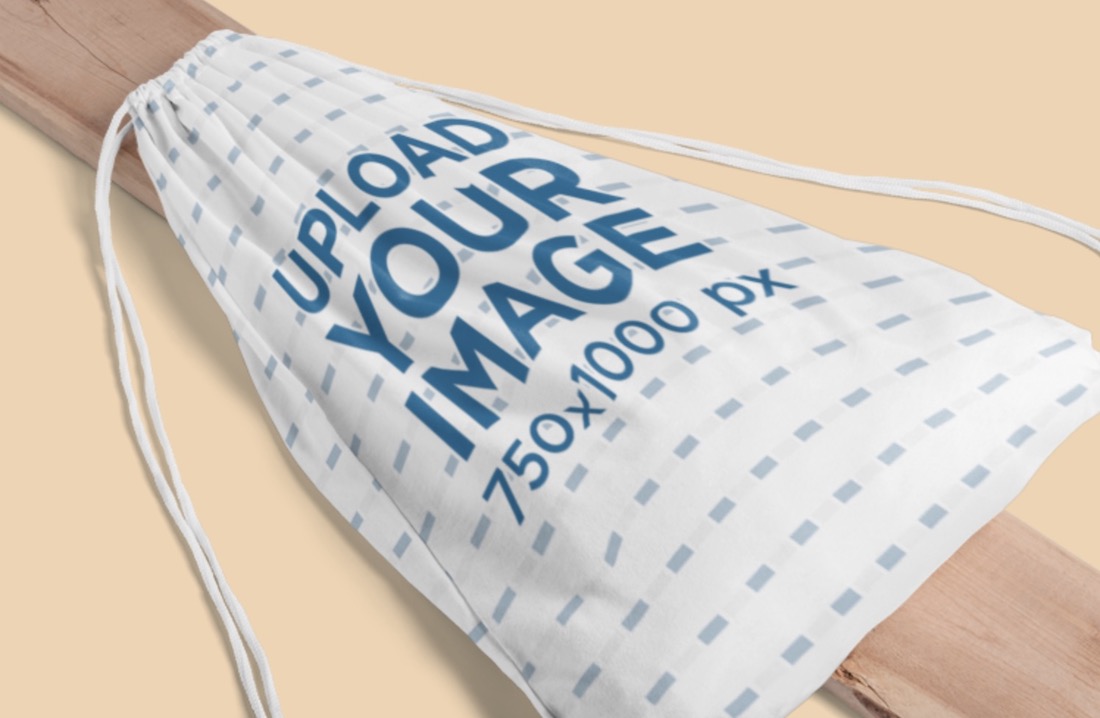 mockup of a drawstring bag placed on a piece of wood