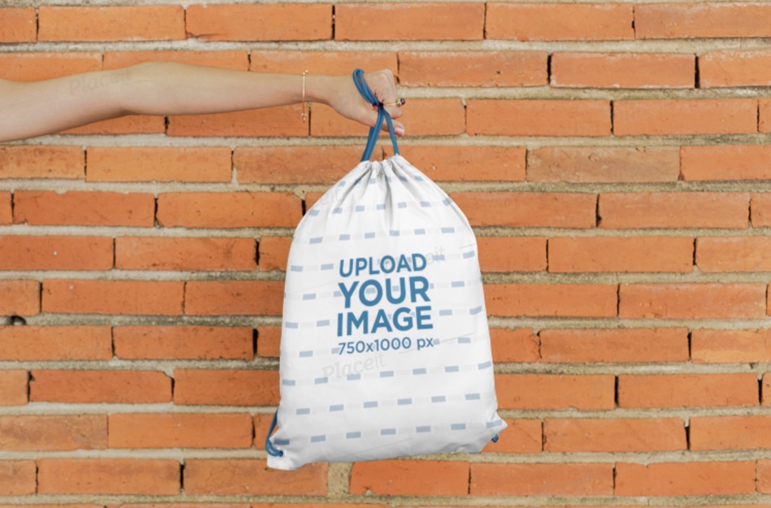 mockup of a hand holding a drawstring bag